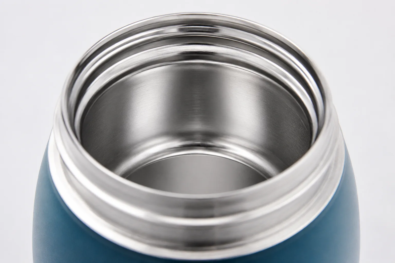 A close-up of the stainless steel interior of a water bottle